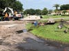 The vehicle came to stop on top of a fire hydrant, damaging the hydrant and causing a hole to form amid the water leak, sending a large amount of dirt into the roadway.