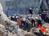 Tampa Bay search-and-rescue workers comb through the rubble of Champlain Towers.