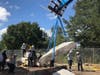 Heavy equipment is used to lift massive pieces of concrete off the rubble.