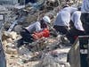 Tampa Bay search-and-rescue workers comb through the rubble of Champlain Towers South Condo.