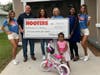 Employees from 12 Tampa Bay area Hooters restaurants volunteered 162 hours to help build a Habitat for Humanity home for a Clearwater family.