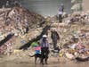 Led by Tampa Fire Rescue driver engineer Britney Bishop, search-and-rescue dog Phorce prepare to begin searching the debris for victims. 