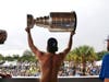 Nikita Kucherov displays the Stanley Cup to the cheering crowd.