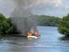 Two boaters were forced to jump off a 20-foot boat following an explosion that caused the boat to catch fire Sunday evening in Tampa Bay.
