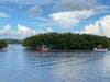 Two boaters were forced to jump off a 20-foot boat following an explosion that caused the boat to catch fire Sunday evening in Tampa Bay.