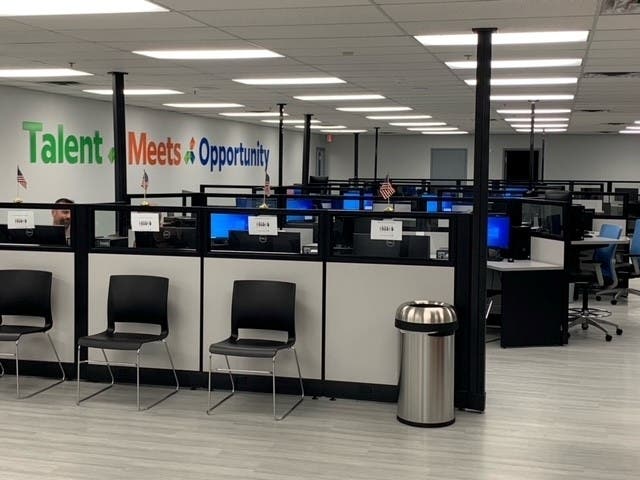 It features a customer resource area with 60 computer workstations, an administration area with 32 employee workstations, a customer waiting area, a conference room, and two computer labs where customer training and work searches can be conducted.
