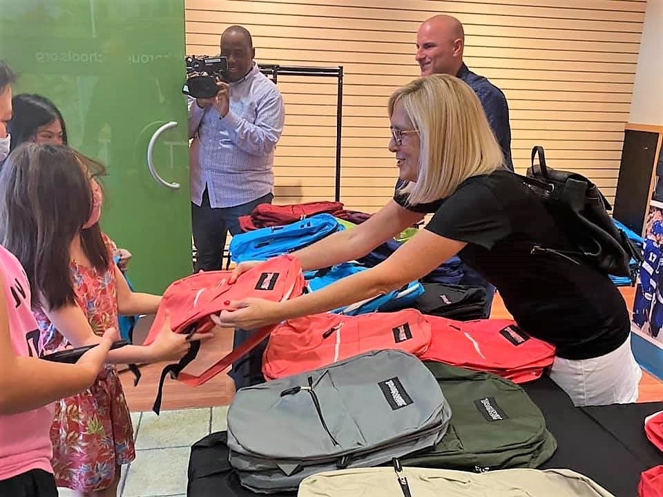 Students receive free backpacks during the annual Back to School Fair at Westshore Plaza Saturday. 
