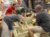 Team Depot at the Zephyrhills Home Depot make outdoor furniture for Volunteers of America. 