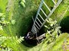 Firefighter Adam Hudson climbs into the 30-foot-deep sinkhole. 