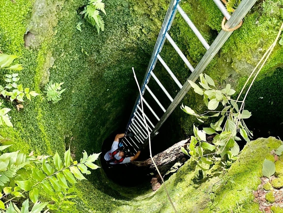 An intrepid High Springs firefighter climbs down a 30-foot-deep sinkhole to rescue a stranded goat. 