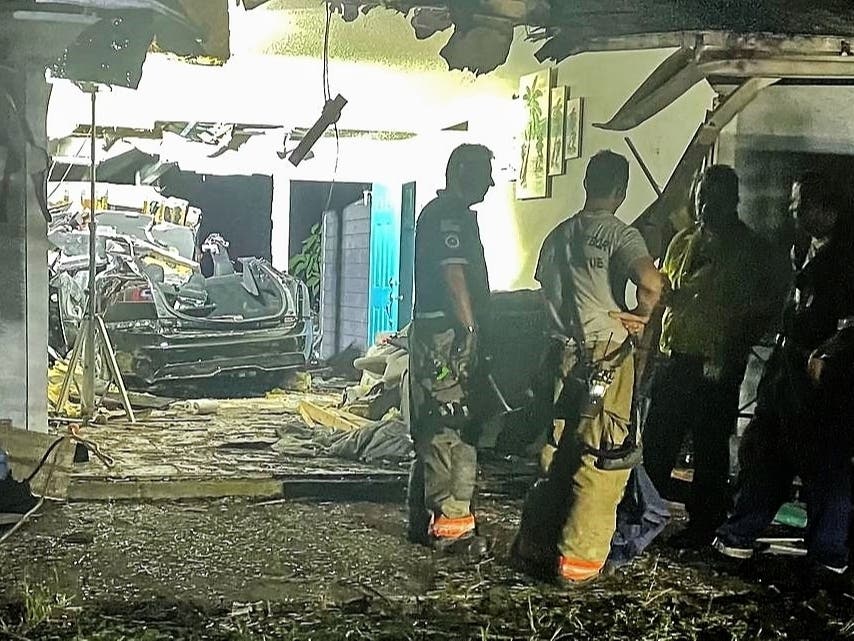 The Tesla penetrated the exterior rear walls of the home and struck one of three people inside, killing her and a Yorkshire terrier.