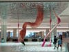 HOME is a massive, floor-to-ceiling sculpture that depicts a hand-sculpted resin and fiberglass flamingo as it gently dips its head beneath the surface of the water. 