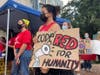 Climate activists rally outside Tampa City Hall.