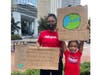 Climate activists rally outside Tampa City Hall.