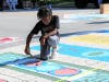 Kids took to the streets with paints and stencils to create an eye-catching street mural designed to make the crosswalks more visible.
