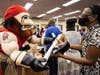 The Tampa Bay Buccaneers foundation presents Young Middle School faculty with a technology donation as part of the Verizon Digital Divide program. 