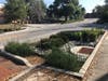 This project on Scott Street implemented roadside bioretention cells with gabions that accept urban stormwater runoff through curb cutouts. The bioretention areas treat the urban runoff before discharging to the city stormwater system.