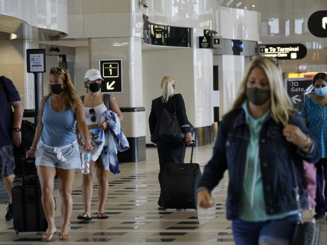 The arrival of the omicron variant prompted the president to extend the mask mandate for travelers. 