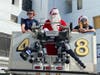 Santa greets children in the hospital from his perch in a fire bucket truck. 