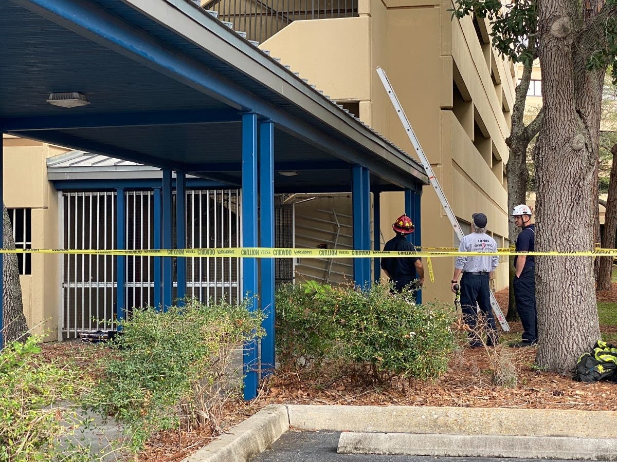 Structural engineers assess the building for safety, determining the best way to safely recover the worker who was trapped inside. 