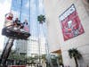 Tampa Mayor Jane Castor and Bucs mascot Captain Fear raise the banner on City Hall to support the Bucs as postseason plays gets underway. 