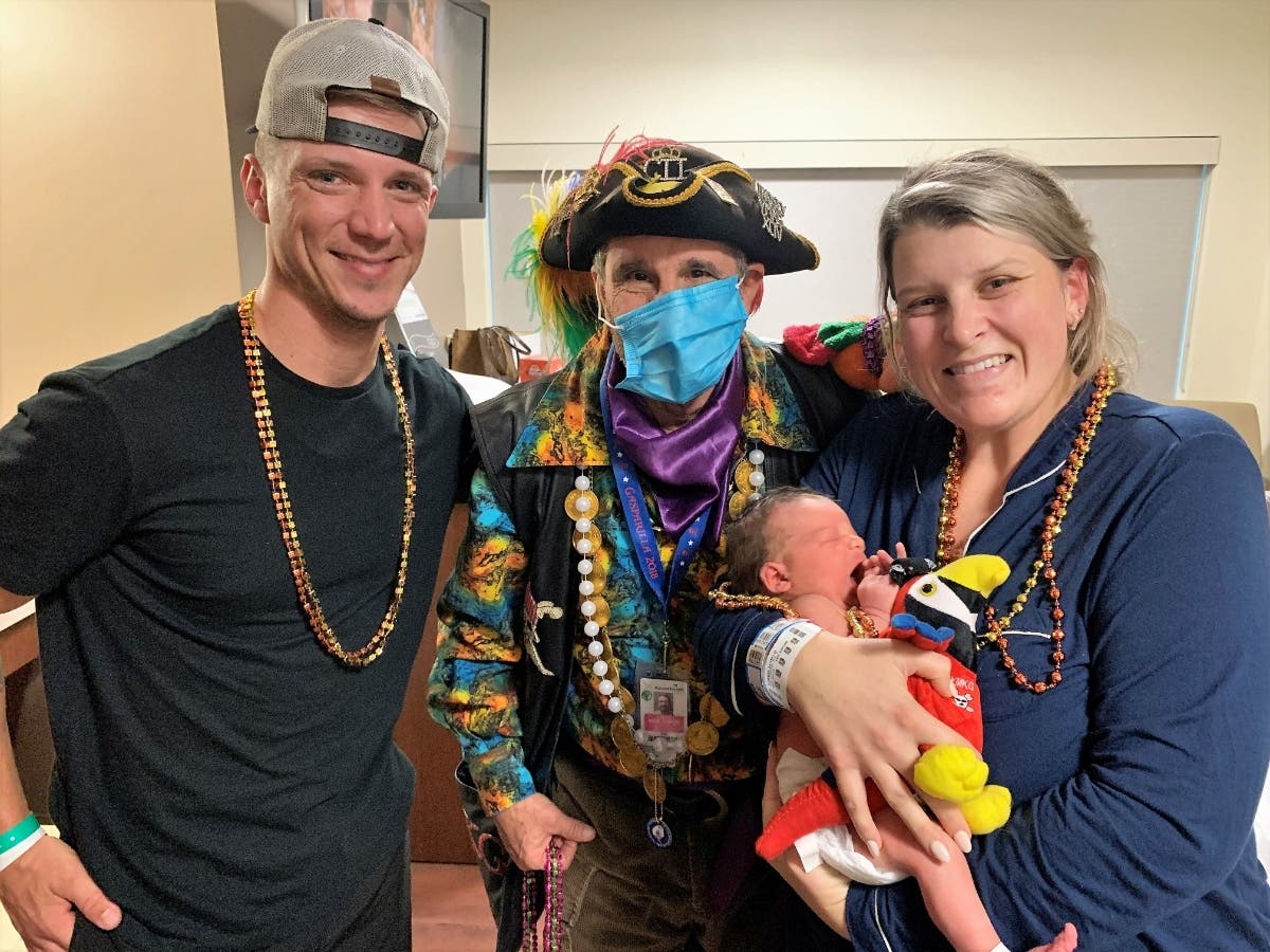 Dr. James Von Thron, a member of Ye Mystic Krewe of Gasparilla, recruits a baby buccaneer.