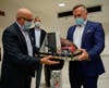 Tampa International Airport CEO Joe Lopano and Edelweiss CEO Bernd Bauer exchange gifts to celebrate the airline's return to Tampa.