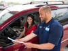 A customer and associate review an online grocery pickup order.