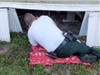 During the heavy thunderstorms Thursday night, a frightened dog seeking shelter crawled beneath a home and into an air duct, where the dog became stuck. 