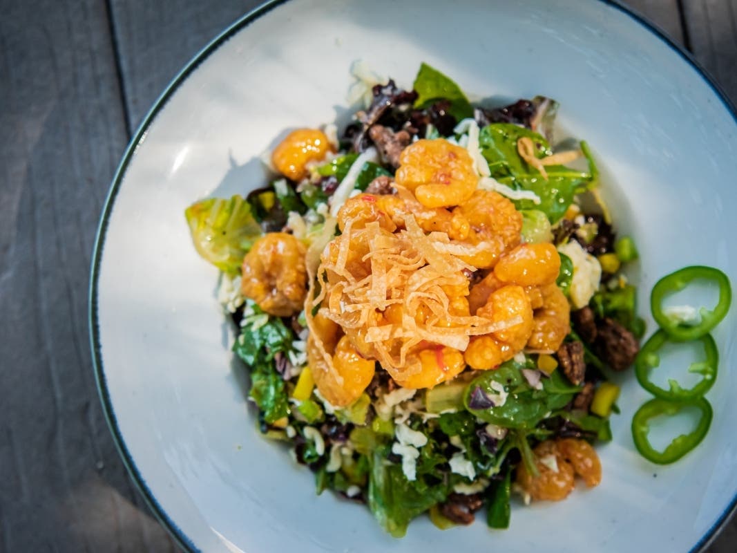 Walk-On's Bistreaux & Bar features Cajun-inspired menu items like the Zydeco salad with sweet chili-glazed fried shrimp, mixed greens, cabbage, candied pecans, jalapeños,
wontons, red onions, bell peppers, jack, vinaigrette with Tabasco and pepper jelly.