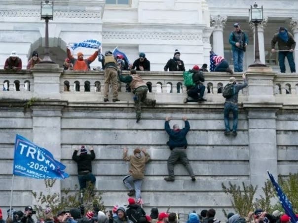 Supporters of President Donald Trump climb the west wall of the U.S. Capitol on Jan. 6, 2021.
