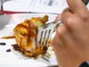 A judge tries a dish prepared by chefs during last year's competition.