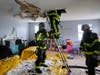 Firefighters examine the attic to ensure that the fire was completely extinguished. 