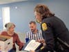 Tampa Police Chief Mary O'Connor presents the officer's daughter, Tammy Krikavak, and grandson, Derek Carroll, with the Purple Shield and Gold Cross.