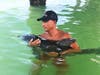 Clearwater Fire & Rescue beach lifeguard Justin West cradles the little dolphin while awaiting the arrival of the Clearwater Marine Aquarium rescue team. 