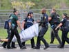 Law enforcement takes a seriously "injured" student to the triage center located in the school parking lot.
