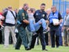 Law enforcement takes an "injured" student to the triage center located in the school parking lot.