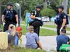 Law enforcement wait with victims for the bus that will transport them to the reunification center. 