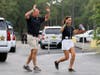Hands raised to indicate that they're unarmed, victims rush to safety outside the school.