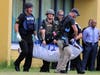 Law enforcement takes a seriously "injured" student to the triage center located in the school parking lot.