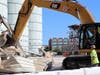 Kimmins Construction crews perform a ceremonial razing of a metal building on the property.