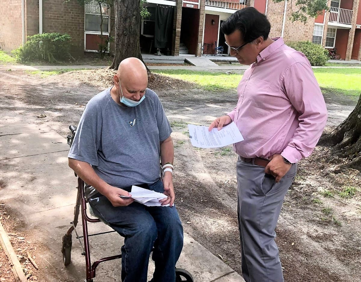 Tampa City Council member Luis Viera talks with a Timber Falls Apartment resident who's received an eviction notice. 