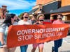 During DeSantis' visit to Ormond Beach, students with tape over their mouths carried a banner reading, "Governor DeSantis Stop Silencing Us." 