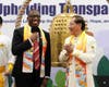 Rev. Dr. Devon Bannister, Pro-Chancellor of CICA International University & Seminary, left, receives a LIFU necktie from Dr. Hong after ringing the Bell. The LI FU collection was founded on the guiding principle of “benefiting all, blessing the world.”