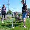 Professional dog trainer Angie DePalma (left) helped residents guide their dogs through the agility course.