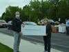 Orland Township Supervisor Paul O’Grady accepts a donation for the Township Food Pantry from Liz Gorman, former Cook County Commissioner.