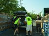 Volunteers load a resident’s car with free food, water and other necessities during a previous grocery distribution held at Orland Township to assist those experiencing financial difficulties due to the COVID-19 pandemic.