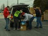 Orland Township Trustee Antonio Rubino (left) loads holiday meal items into residents’ vehicles.