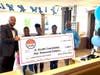 The Poore Organization presents a check to the IU Health Foundation at the restaurant's Grand Reopening on September 13