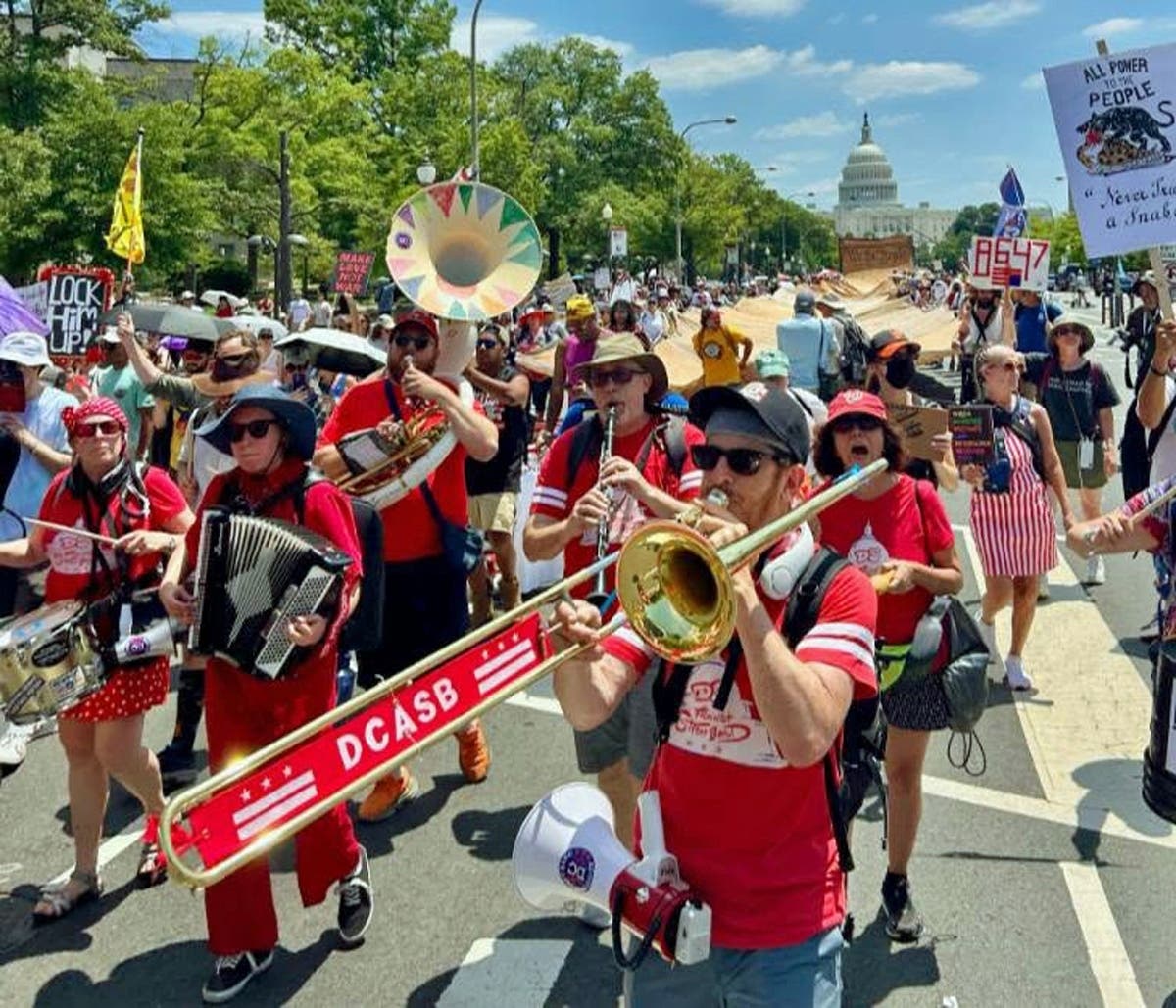 DC Activist Street Band, followed by the 700-foot-long "We the People" preamble banner, during the We The People 250 March, held in DC on July 4, 2026.